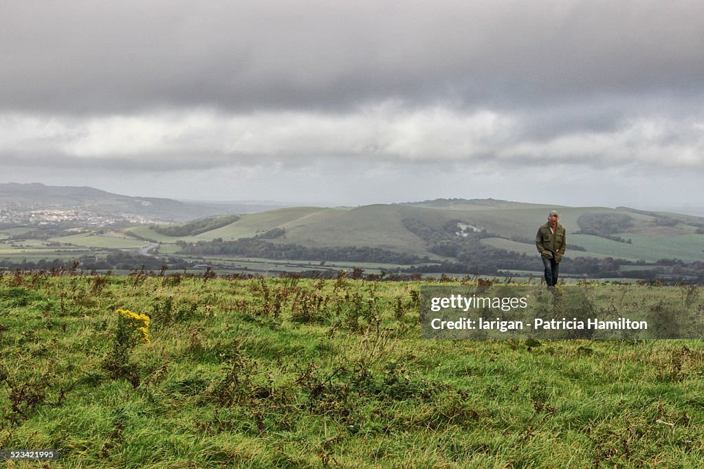 Man walking on South Downs on a blustery day