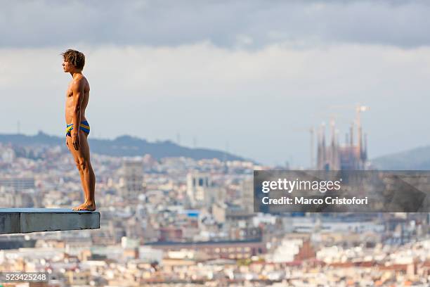 athlete standing on diving board with cityscape in background, barcelona, spain - badkläder bildbanksfoton och bilder