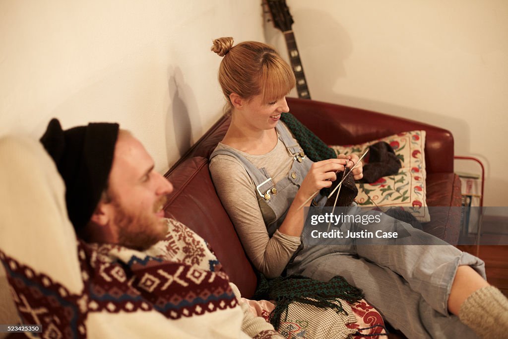 A man and a woman relaxing in a sofa
