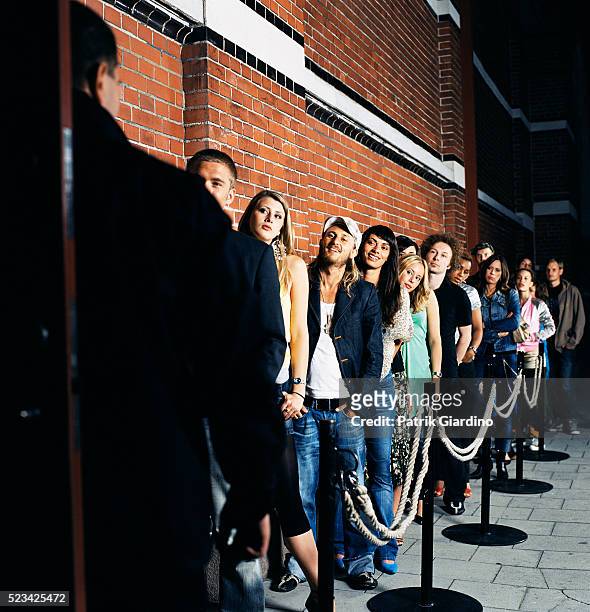 waiting in line outside nightclub - lining up stock-fotos und bilder