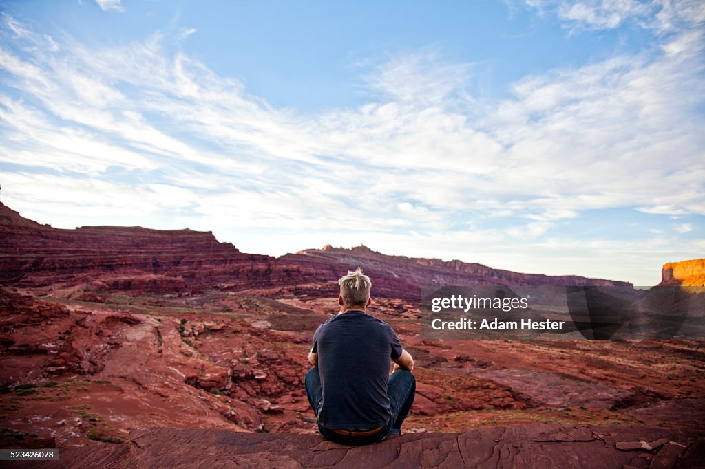 Young man relaxing on desert, Moab, Utah, USA