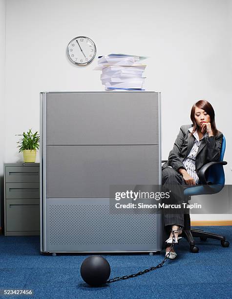 businesswoman wearing ball and chain - ball and chain stock pictures, royalty-free photos & images