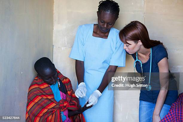 doctor and nurse undertaking blood test with patient, kenya - east africa stock pictures, royalty-free photos & images