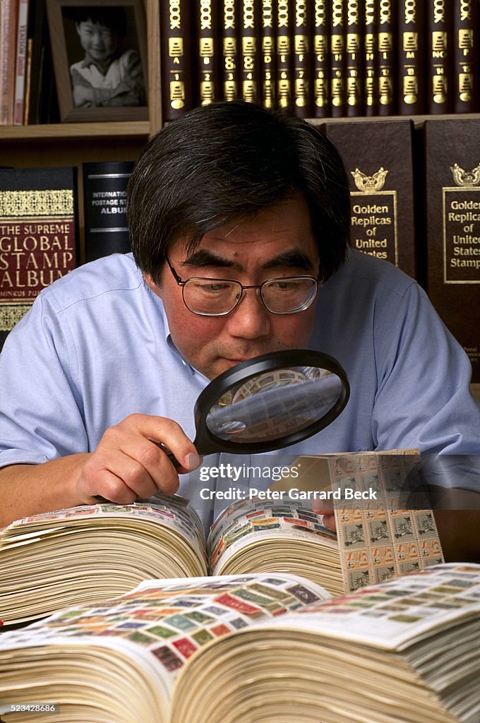 Stamp collector examining stamps