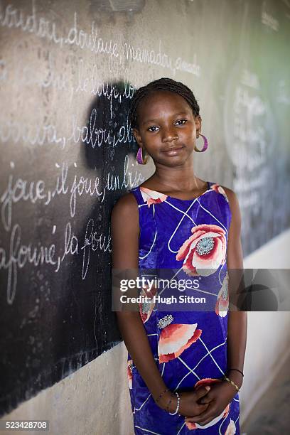 student leaning against blackboard - áfrica del oeste fotografías e imágenes de stock