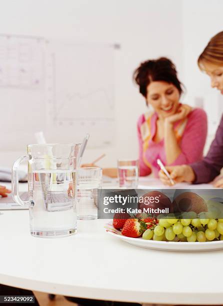two businesswomen working in office - fruit bowl stock pictures, royalty-free photos & images
