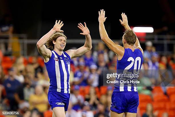 Ben Brown of the Kangaroos celebrates a goal during the round five AFL match between the Gold Coast Suns and the North Melbourne Kangaroos at...