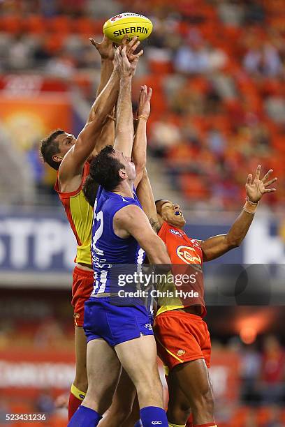 Callum Ah Chee of the Suns and Todd Goldstein of the Kangaroos compete for the ball during the round five AFL match between the Gold Coast Suns and...