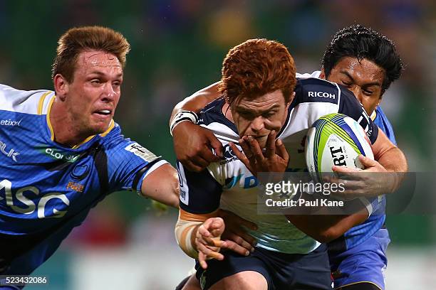 Andrew Kellaway of the Waratahs gets tackled by Dane Haylett-Petty and Ben Tapuai of the Force during the round nine Super Rugby match between the...