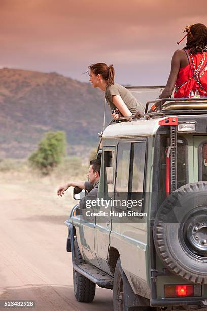 couple on safari - ethnic woman driving a car stock pictures, royalty-free photos & images