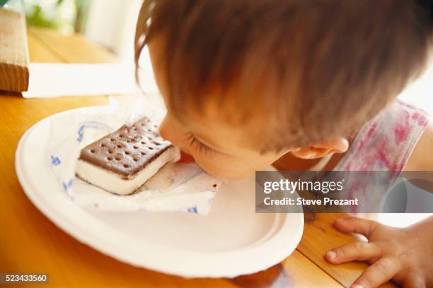 Infant Eating Ice Cream Sandwich High-Res Stock Photo