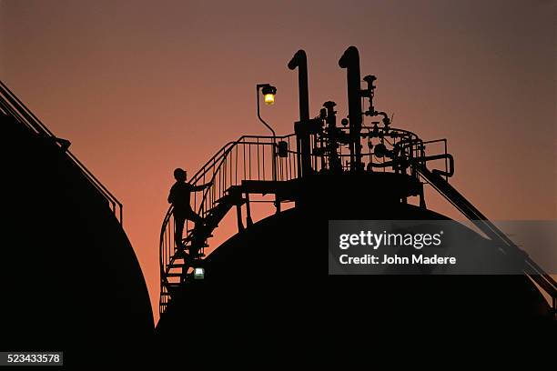 climbing ladder on chemical tank - lighting technique stockfoto's en -beelden