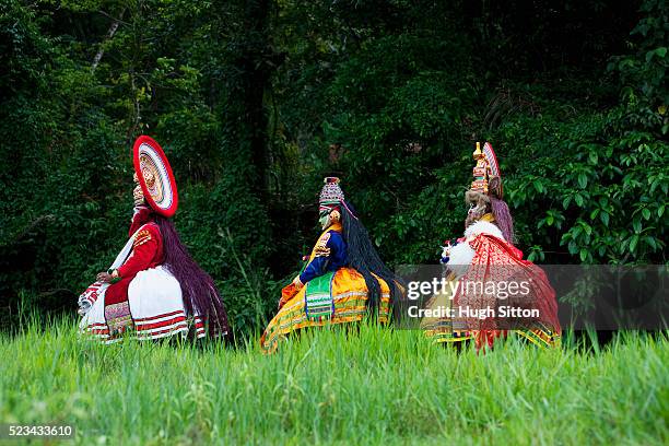 three kathakali dancers walking together, southern india - hugh sitton india stockfoto's en -beelden