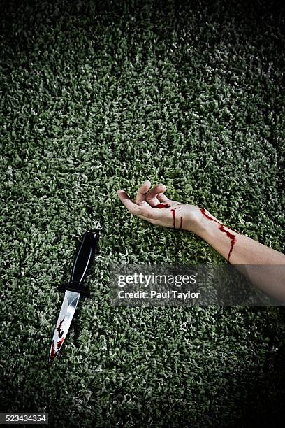 hand of murdered woman lying by a bloody knife - dead person stock pictures, royalty-free photos & images