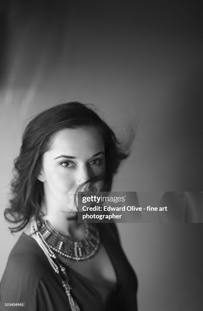 Black and white studio portrait of young woman
