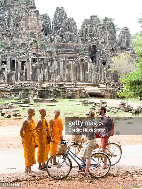 tourists talking with local monks, angkor wat, cambodia - angkor stock pictures, royalty-free photos & images