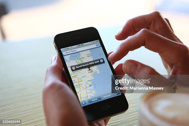 woman using google maps on her iphone - australia capital cities map stock pictures, royalty-free photos & images