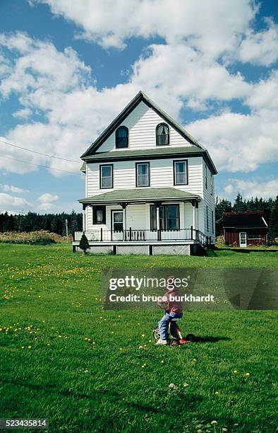 little boy looking at farmhouse - vintage house stock pictures, royalty-free photos & images
