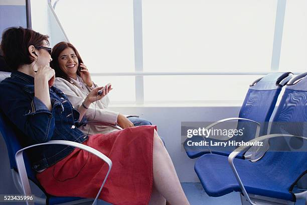 smiling women with cell phones on ferry - commuter ferry stock pictures, royalty-free photos & images