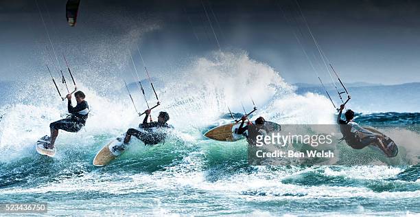 kitesurfer surfing a wave - kite surfing stock pictures, royalty-free photos & images