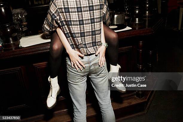 girl holding her hands on boys bottom - comportamento sessuale umano foto e immagini stock