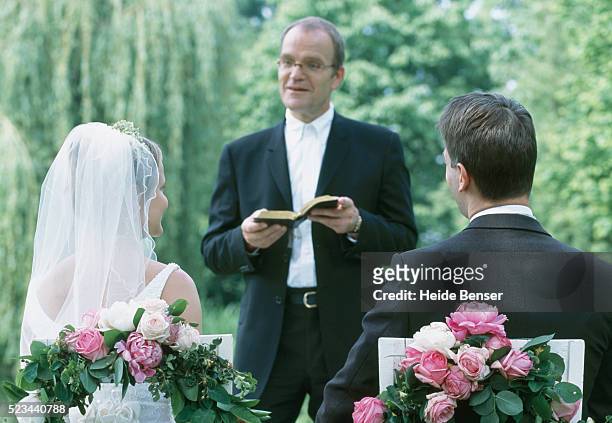 bride and groom at marriage ceremony - priests talking stock pictures, royalty-free photos & images