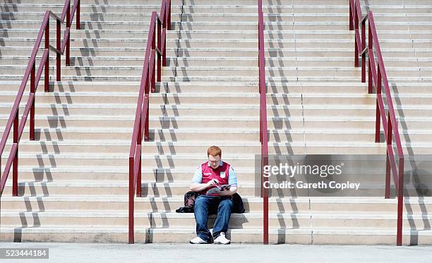 Supporter reads the match day magazine prior to the Barclays Premier League match between Aston Villa and Southampton at Villa Park on April 23, 2016...