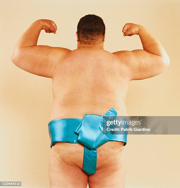 sumo wrestler flexing his biceps - ringen stock-fotos und bilder