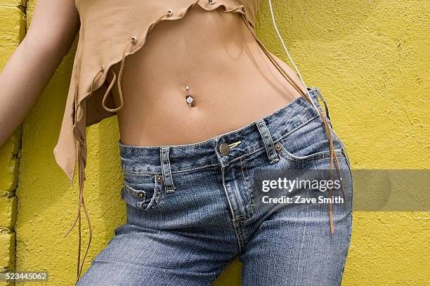 young woman with pierced midriff - bauchnabelring stock-fotos und bilder