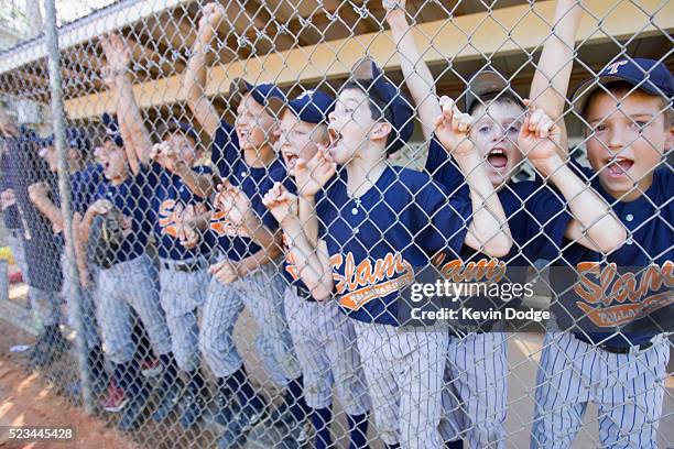 little league team shouting from dugout - sports dugout stock pictures, royalty-free photos & images