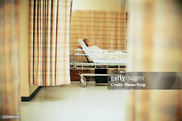 woman lying in a hospital bed - archival hospital stock pictures, royalty-free photos & images