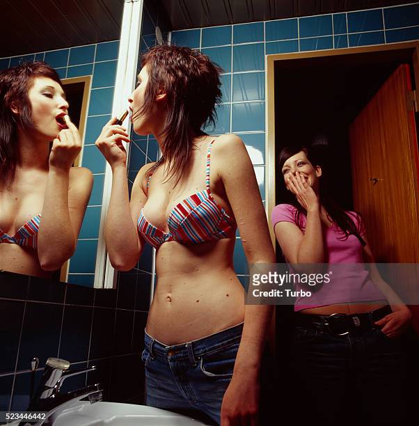 two young women in bathroom - vintage hand mirror stock pictures, royalty-free photos & images