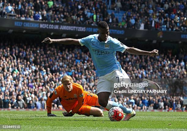 Manchester City's Nigerian striker Kelechi Iheanacho goes around Stoke City's Danish goalkeeper Jakob Haugaard to score their fourth goal during the...