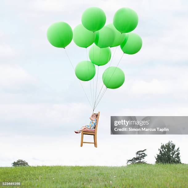 child sitting in chair tied to balloons - tied to chair stock pictures, royalty-free photos & images