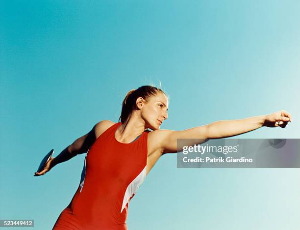 athlete throwing discuss - フィールド競技 ストックフォトと画像