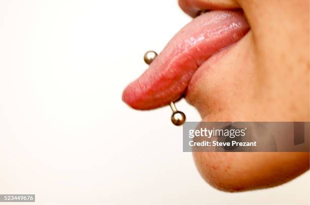 teenager with tongue piercing - body piercings stock-fotos und bilder