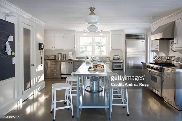 white and stainless steel kitchen with cement floor - kitchen island stock pictures, royalty-free photos & images