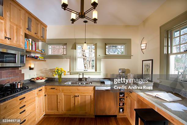 kitchen with wood cabinets and granite countertop - casa in esposizione foto e immagini stock