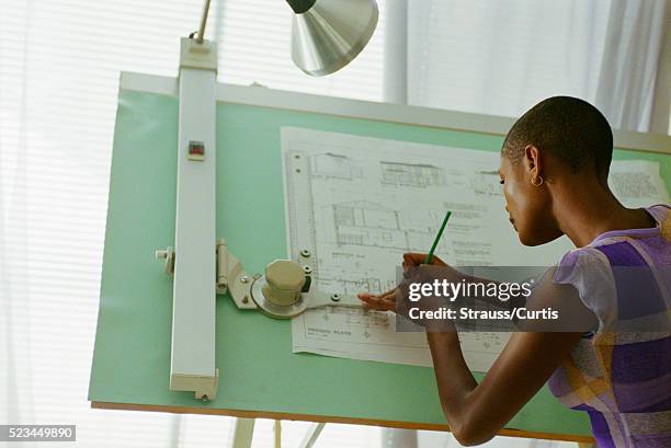 architect sketching at drafting table - architect imagens e fotografias de stock