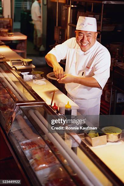 chef preparing food at restaurant - sushi bar stock pictures, royalty-free photos & images