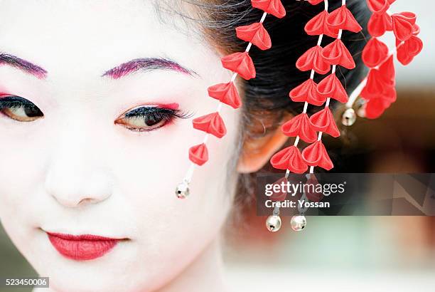 maiko with red hair ornament - geisha in training stock pictures, royalty-free photos & images