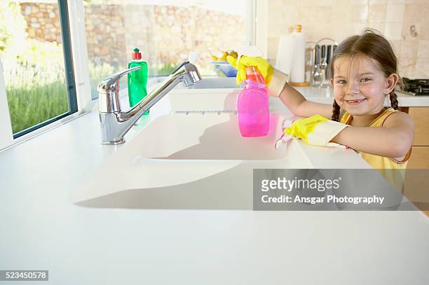 young girl cleaning kitchen - kids with cleaning rubber gloves 個照片及圖片檔