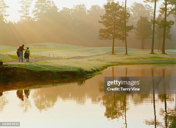 father and son playing golf - father son golf stock pictures, royalty-free photos & images