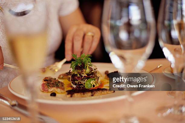 woman eating a fancy salad - vintage restaurant foto e immagini stock