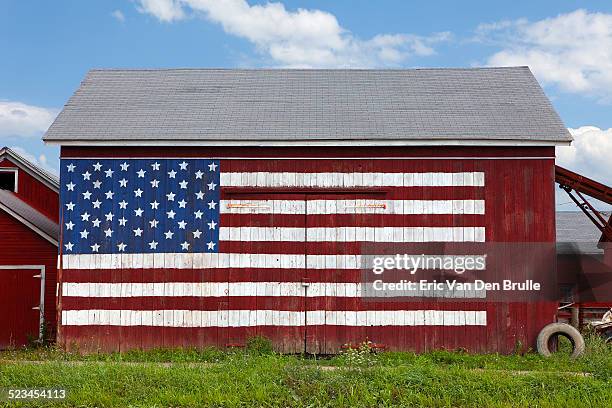 usa flag painted on red barn - eric van den brulle stock-fotos und bilder