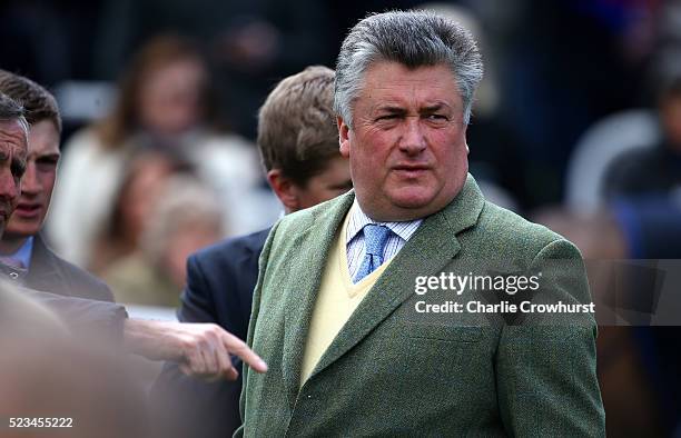 Trainer Paul Nicholls looks on in the parade ring ahead of the first race at Sandown racecourse on April 23, 2016 in Esher, England.