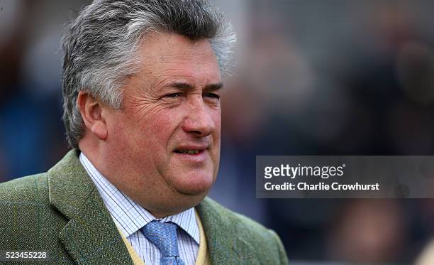 Trainer Paul Nicholls looks on in the parade ring ahead of the first race at Sandown racecourse on April 23, 2016 in Esher, England.