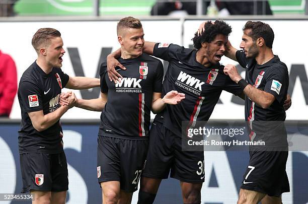 Alfred Finnbogason of Augsburg celebrates after scoring his team's opening goal with Philipp Max , Caiuby and Halil Altintop of Augsburg during the...