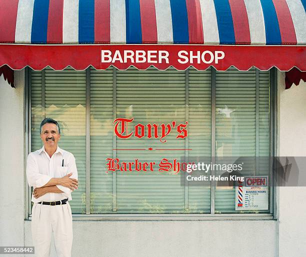 barber standing outside his shop - barber shop stockfoto's en -beelden