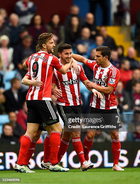 Shane Long of Southampton celebrates with Jay Rodriguez of Southampton and Cedric Soares of Southampton after scoring the opening goal during the...